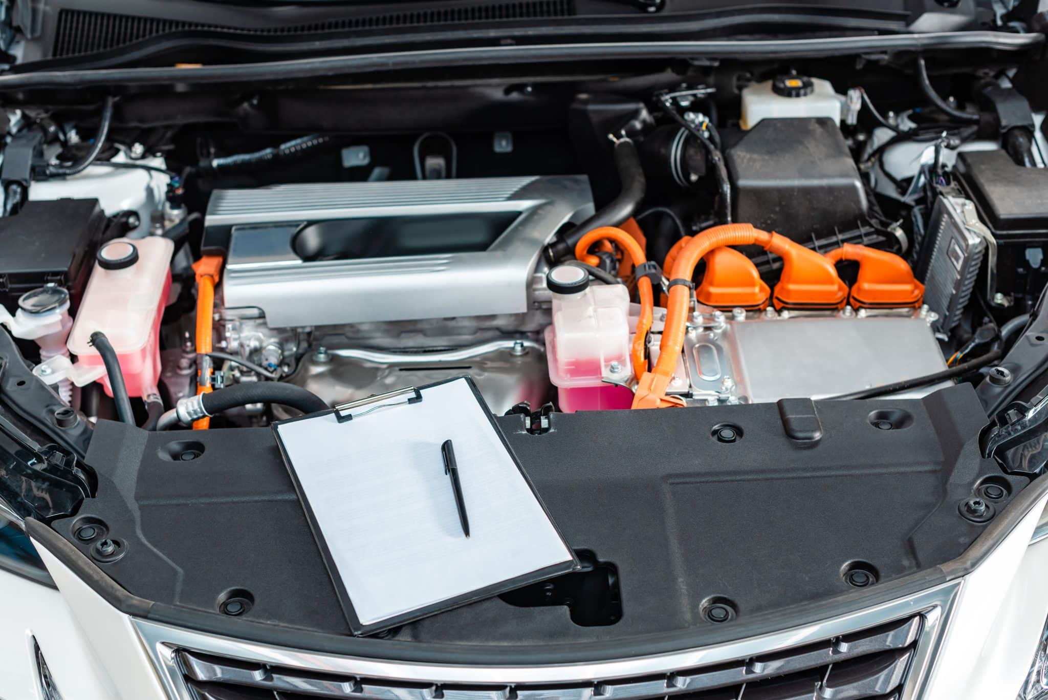 How to Keep Running Costs Low for Electric Utility Vehicles 2 open engine hood with clipboard and pen 2026 01 06 00 25 23 utc scaled