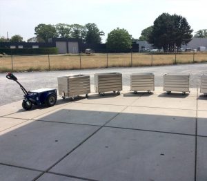 Jobmaster HD Electric Pedestrian Tug towing metal containers