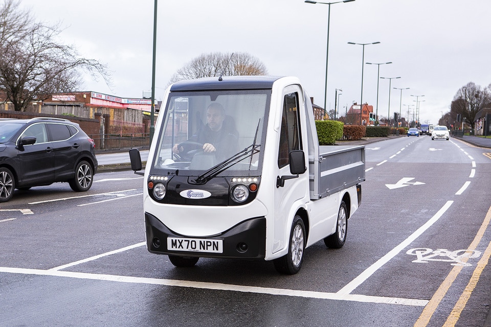 Man driving X-Cell Road Legal Electric Utility Vehicle